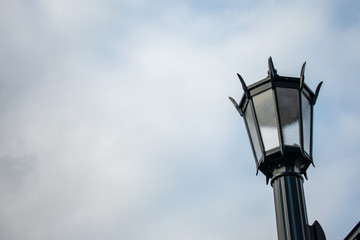 An Old Fashion Street Lamp Against a Cloudy Sky