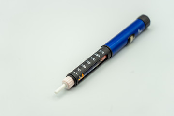 An insulin injection pen used by diabetics with insulin inside isolated on a white background