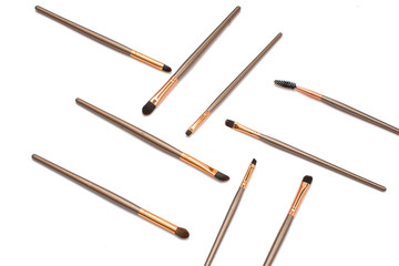 Brochas de maquillaje acomodadas de manera estética sobre un fondo blanco
