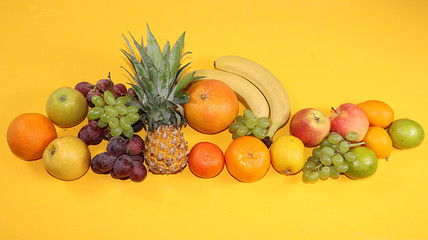Obraz na płótnie Canvas Summer banner, citrus fruits, grapefruit, orange, lemon, bananas on a yellow background, minimal concept of relaxation, diet, healthy food. Place for text, flat lay, home delivery service.