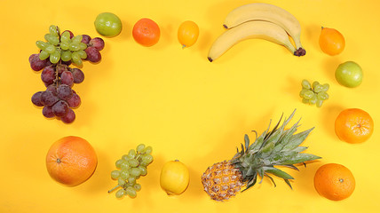 Summer banner, citrus fruits, grapefruit, orange, lemon, bananas on a yellow background, minimal concept of relaxation, diet, healthy food. Place for text, flat lay, home delivery service.