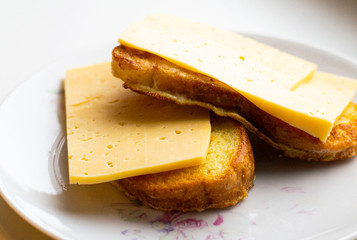 fried slices of white bread with cheese on a plate.