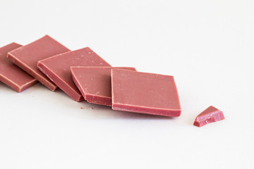 Natural Pink Color Ruby Chocolate sliced on white with copy space.