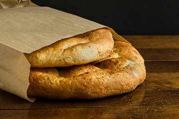 Traditional Turkish,Fresh,Circular Ramadan Bread in craft paper bag.Conceptual image of Ramadan.