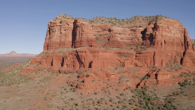 A drone flying to the left with Courthouse Butte and Bell Rock in Sedona, Arizona.