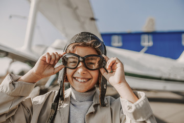 Smiling little boy wearing aviator glasses outdoors