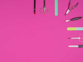 Accessories manicure on pink background.