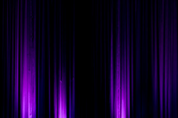 Black backdrop with purple lights in a city theater
