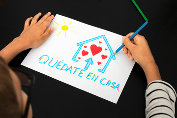 Quarantine in Spain. Kid hand draw picture with spanish words Quedate en casa - Stay at home