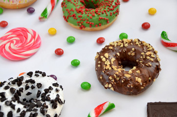  donuts and different sweets on a white background