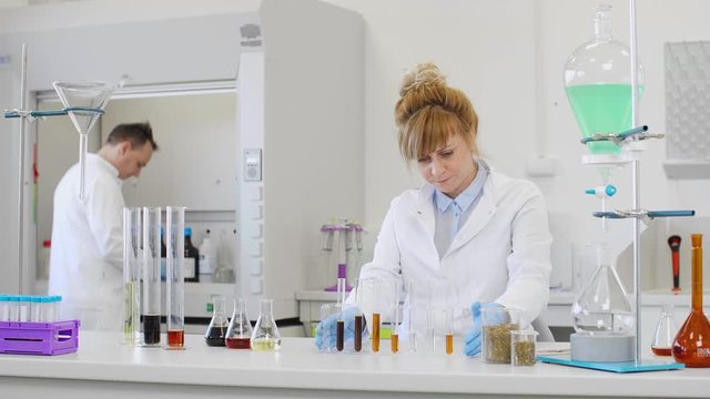 Chemist working with hemp CBD oil in laboratory