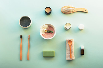 Top view hygiene items and natural cosmetics on blue background. Beauty, spa and wellness concept.
