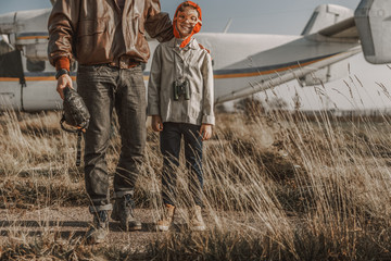 Young father looking at his son near plane