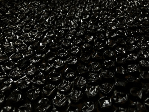 Black plastic popping bubble wrap