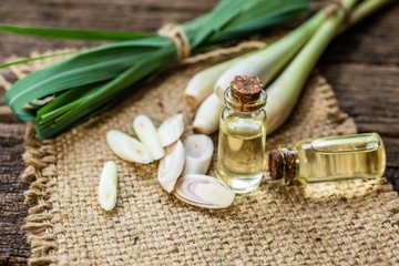Lemongrass essential oils placed on a wooden table. spa concept.