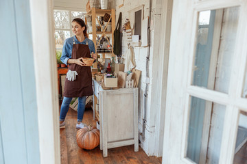 Pleased young Caucasian female florist looking away