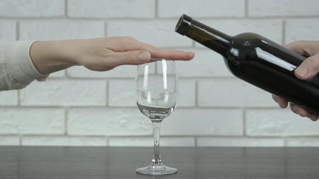 Stop gesture to alcohol.