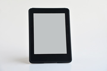 Digital e-book reader stand on the white background.Blank screen is ready for any text message.Close up taken.