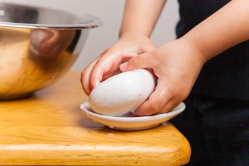 a small child independently takes soap from a soap dish to propensify his hands. Prevention of viruses and SARS. Teaching young children the basics of hygiene.
