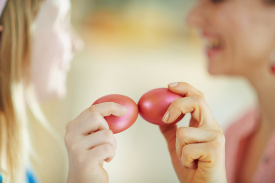 Smiling Mother And Daughter Having Egg Tapping With Easter Eggs