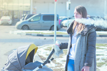 smoking vaping young mother with a stroller, pram