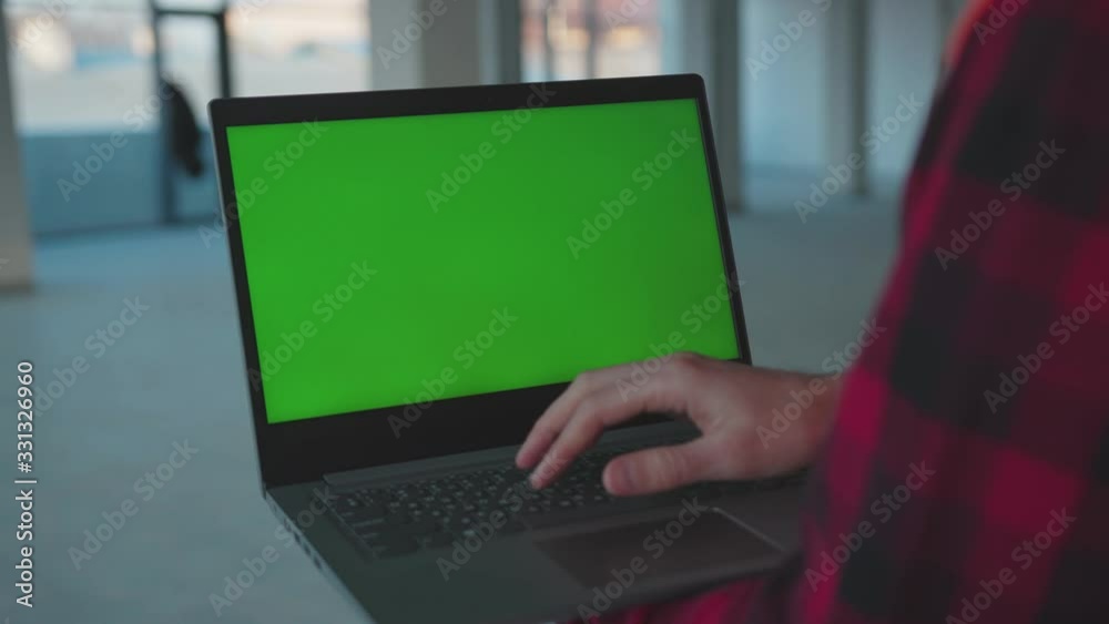Wall mural man hands engineer using laptop computer with green screen inside building worker project occupation