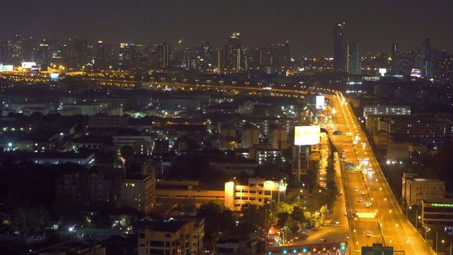 Aerial view of highway steet roads in Bangkok Downtown skyline, Thailand. Financial business district and residential area in smart urban city. Skyscraper and high-rise buildings at night time.