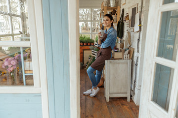 Cheerful female in work clothes relaxing indoors