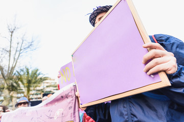 Blank banners held by people during demonstrations, to be completed with text.