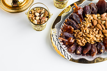Close up taken,Luxury Dry Date Fruits,walnut,pistachio,hazelnuts and almonds in the stylish,golden tray,Copy space,Conceptual image of Islamic Tradition Ramadan.