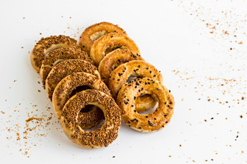 Traditional Turkish Kandil Sesame Rings  which is eaten on Kandils.Kandil is one of the five Islamic holy nights :Mevlid,Regaip,Mirac,Berat,Kadir. Sesame rings with tea on white.