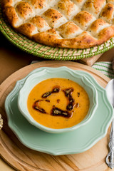 Traditional Ramadan,Iftar Dinner with Turkish Soup and Ramadan Bread on wooden plate.
