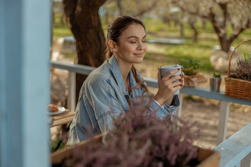 Pleased girl enjoying fresh air in the country