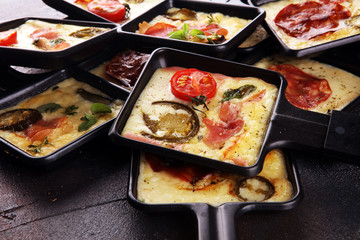 Delicious traditional Swiss melted raclette cheese on diced boiled or baked potato.