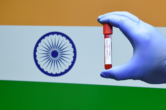 Corona Virus Or Covid-19 In India, Sample Blood Tube In Hand With India Flag On Background