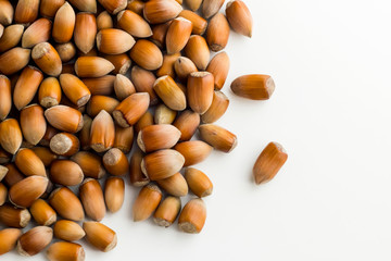 Ripe,new crop hazelnuts heap on white background with copy space