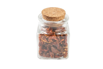dried tomatoes in a glass jar isolated on white background. spices and food ingredients