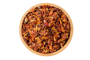 dried tomatoes in wooden bowl isolated on white background. spices and food ingredients