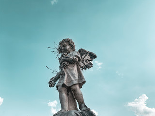 statue of an angel on background of blue sky
