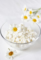 Homemade cottage cheese and cream in glassware. on a white background. Soft focus. Copy Space