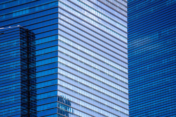High glass skyscrapers on the streets of Singapore. Office windows background, closeup