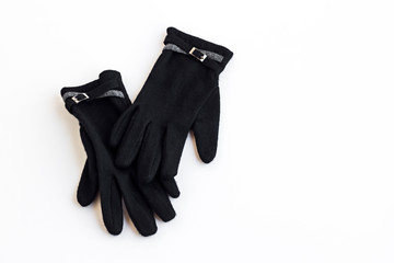 A pair of woolen stylish black gloves for ladies on the white ground with copy space
