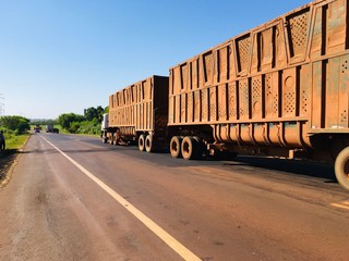 Dourados, Mato Grosso do Sul, Brazil - March 14, 2020. Beautiful day with blue and cloudless sky. Brazilian highways, Anel Viário Norte (ring road north), Brazilian roads, we see trucks at high speed.