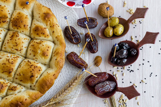 Traditional Ramadan bread with dry date fruits,olives,walnuts and wheat ears.Conceptual image of Ramadan.