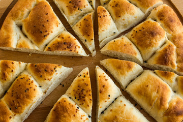Triangle sliced ramadan bread,pide on the wooden plate.