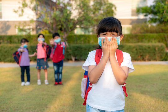 Asian girl preschool child student wearing healthy face mask sneeze. Social distancing recommends at least one meter of distance between yourself and people who are coughing or sneezing.