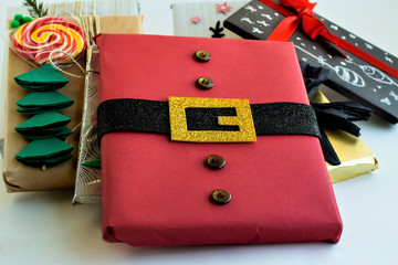 Handmade new year presents prepared one selected in shape santa claus red coat.White background,