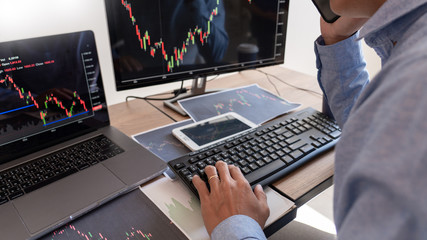 Businessman broker Analyzing finance data graphs and reports on screen for investment purposes for trading graph of stock market.