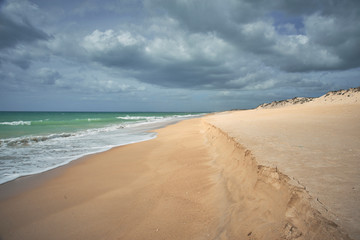 Fototapeta na wymiar Faro, Algarve / Portugal - March 07, 2020: Atlantic ocean view. Typical beach in Algarve. Praia da Quinta do Lago