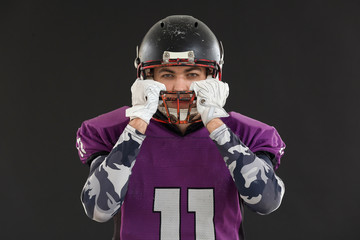 American football player on dark background